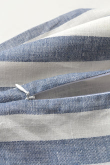 Close up photo of blue & white linen pillow with zipper