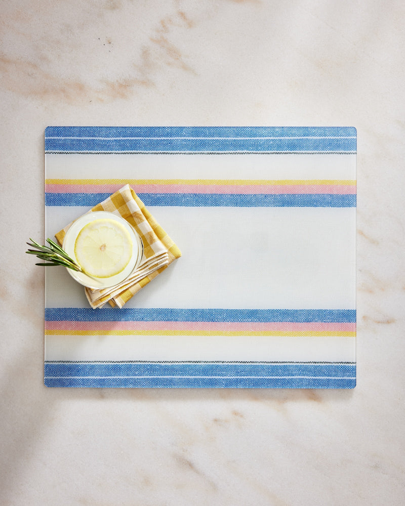 Striped placemat with lemon and rosemary on a marble surface