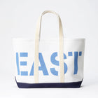 White tote bag with blue 'EAST' text on a white background
