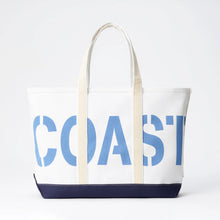 Tote bag with 'COAST' printed on it against a white background