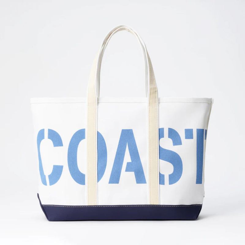 Tote bag with 'COAST' printed on it against a white background