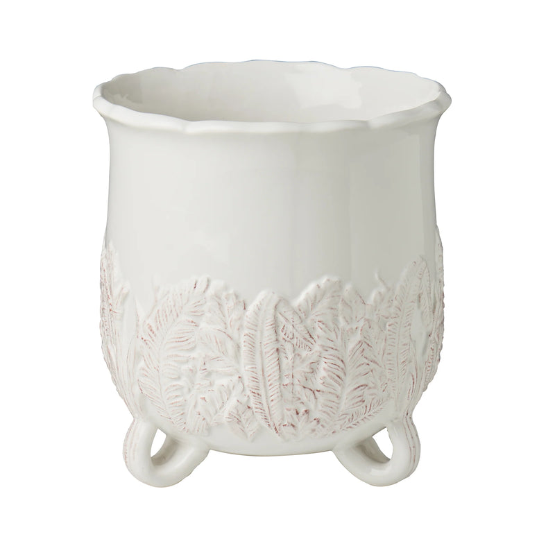 White ceramic planter with floral patterns on a white background