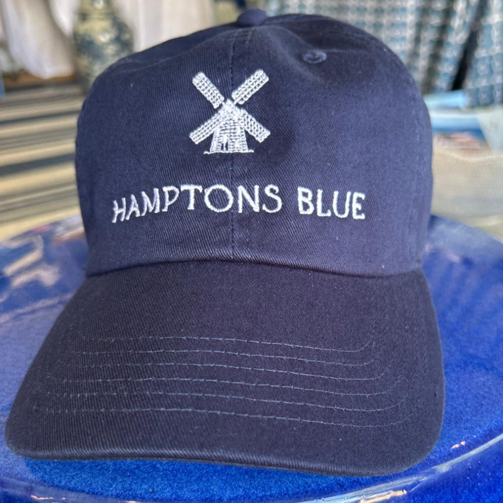 A blue baseball cap with a blue windmill logo on the side.