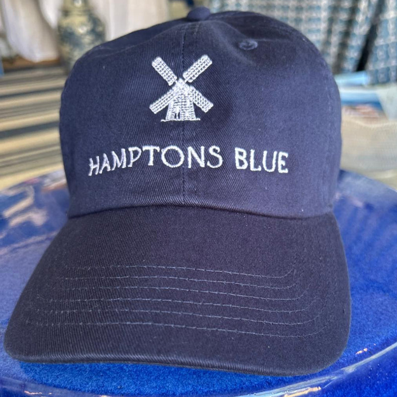A blue baseball cap with a blue windmill logo on the side.