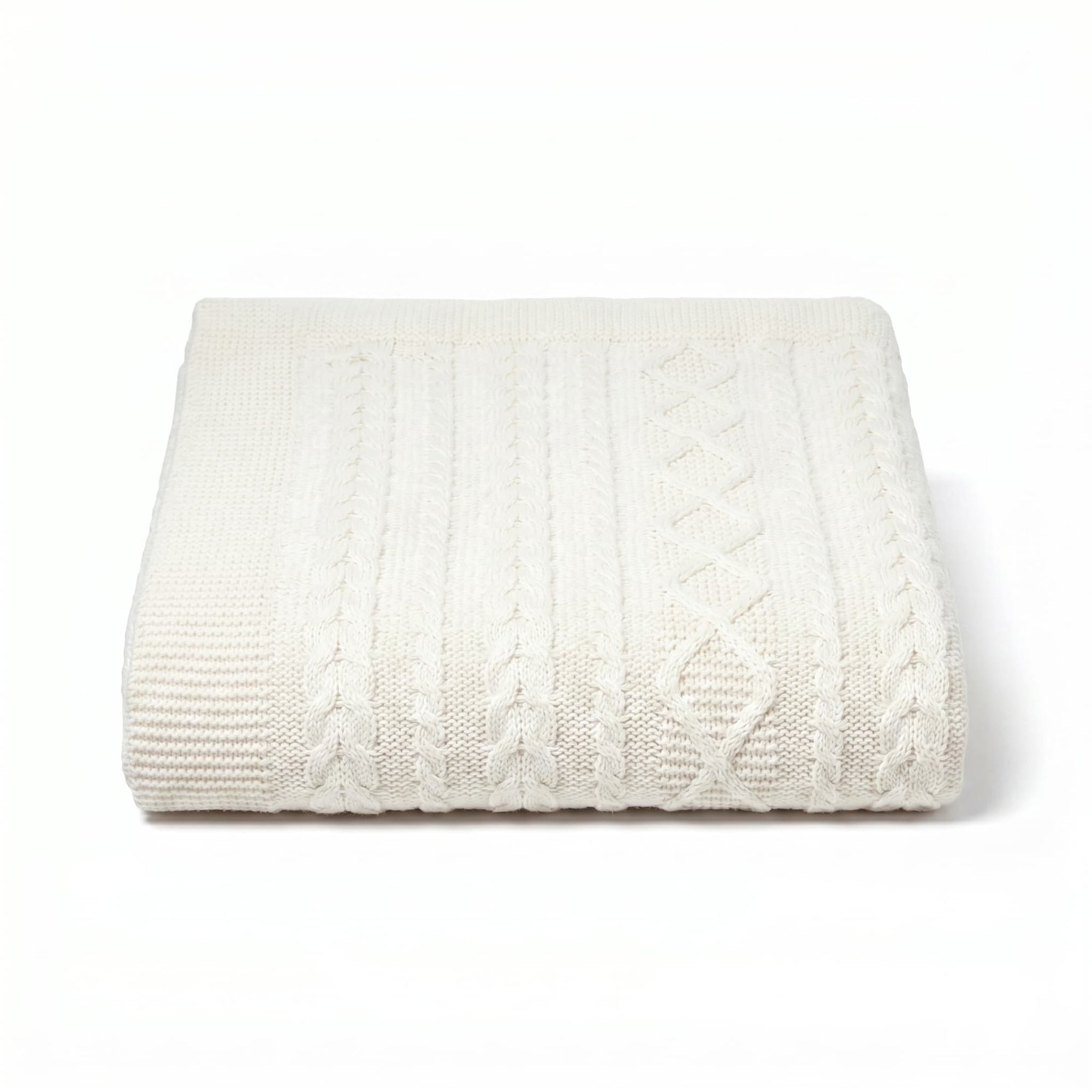 White cable knit blanket on a white background