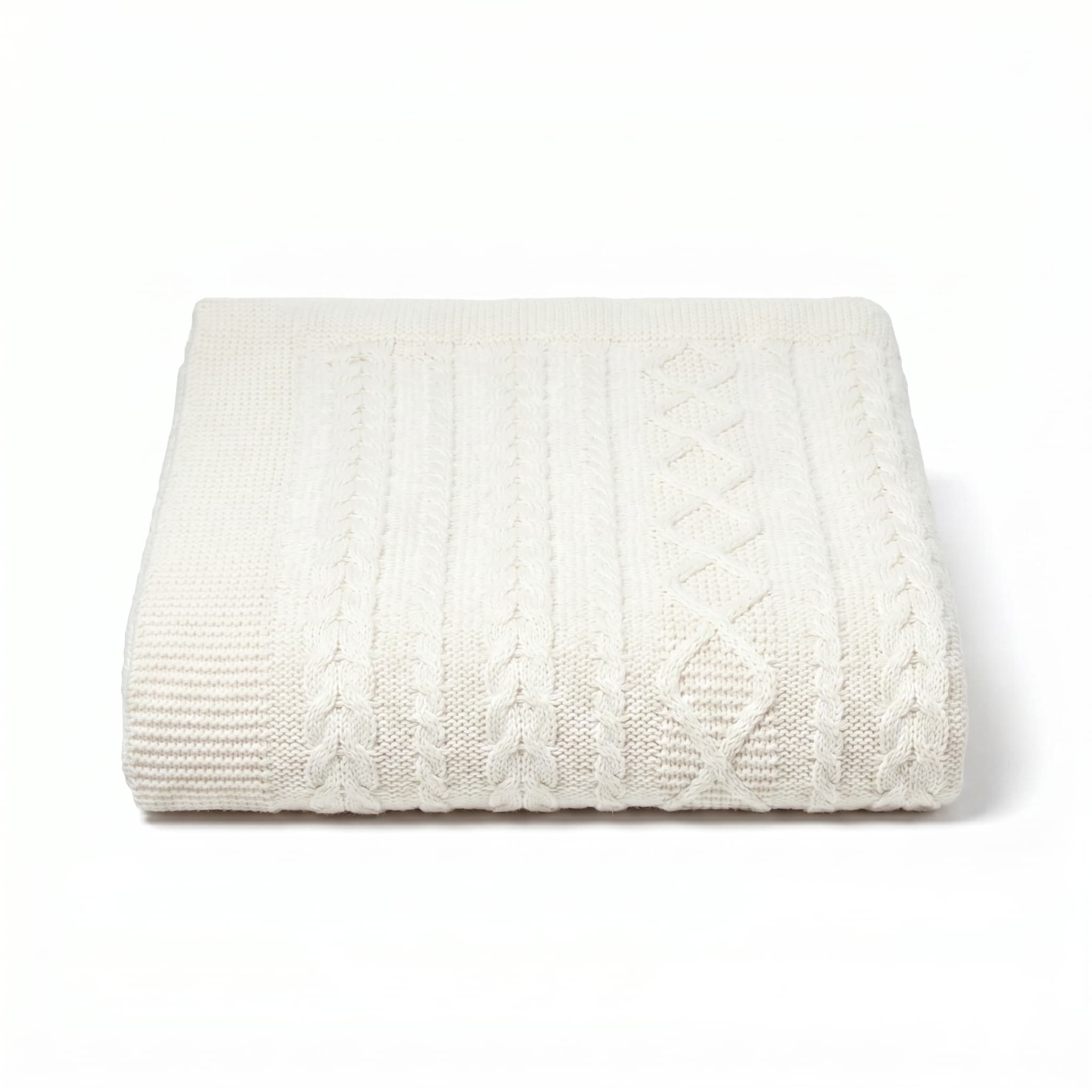 White cable knit blanket on a white background