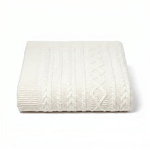 White cable knit blanket on a white background
