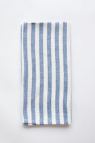 Blue and white stripe linen napkin on a white background