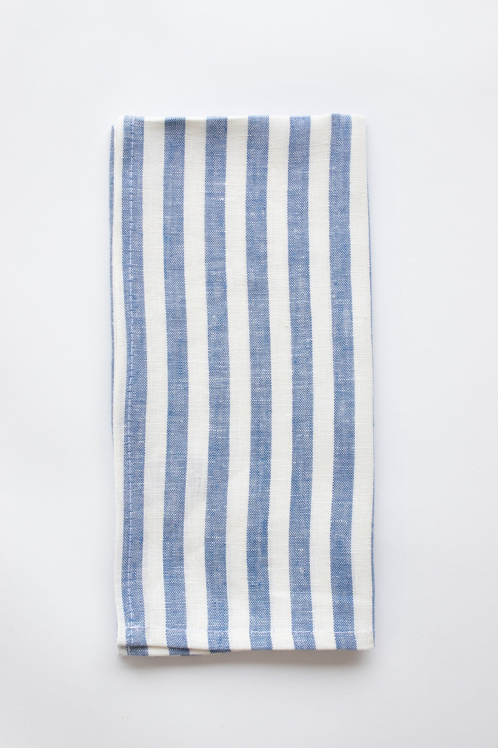 Blue and white stripe linen napkin on a white background