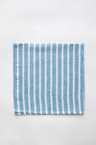 Blue and white striped napkin on white background