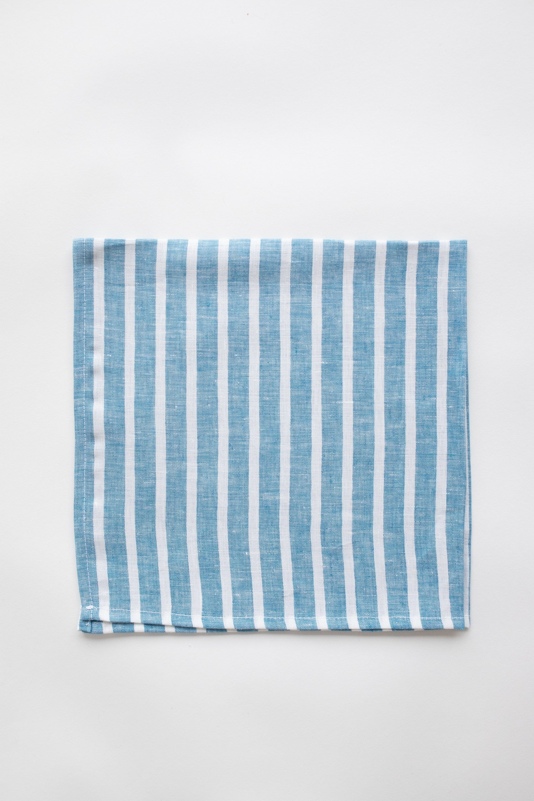 Blue and white striped napkin on white background