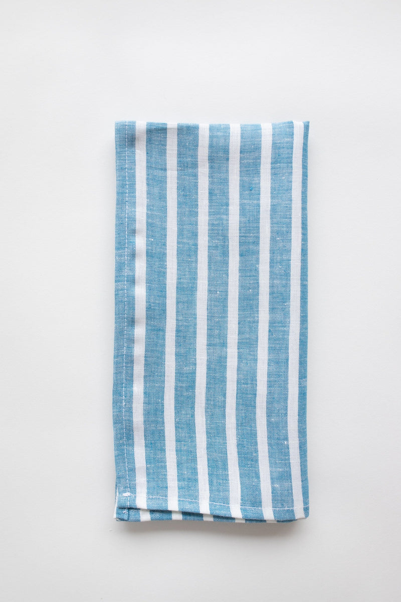 Blue and white linen stripe napkin on white background