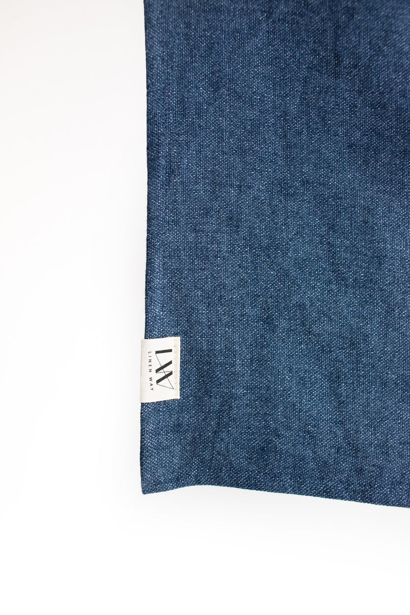 Close up of navy linen napkin and label