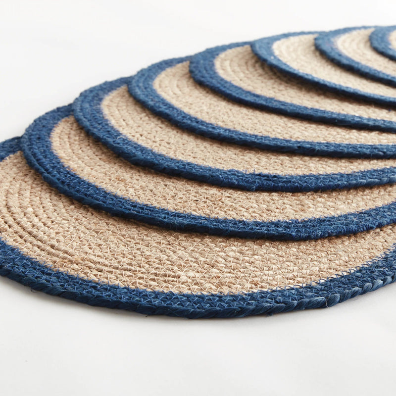 Set of round woven coasters with blue and beige pattern on a white background