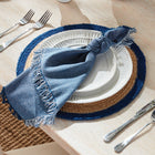 Placemat with blue napkin and white plates on a wooden table