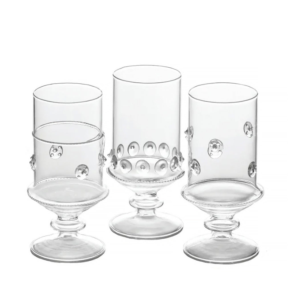 Set of four clear glass goblets with decorative elements on a white background