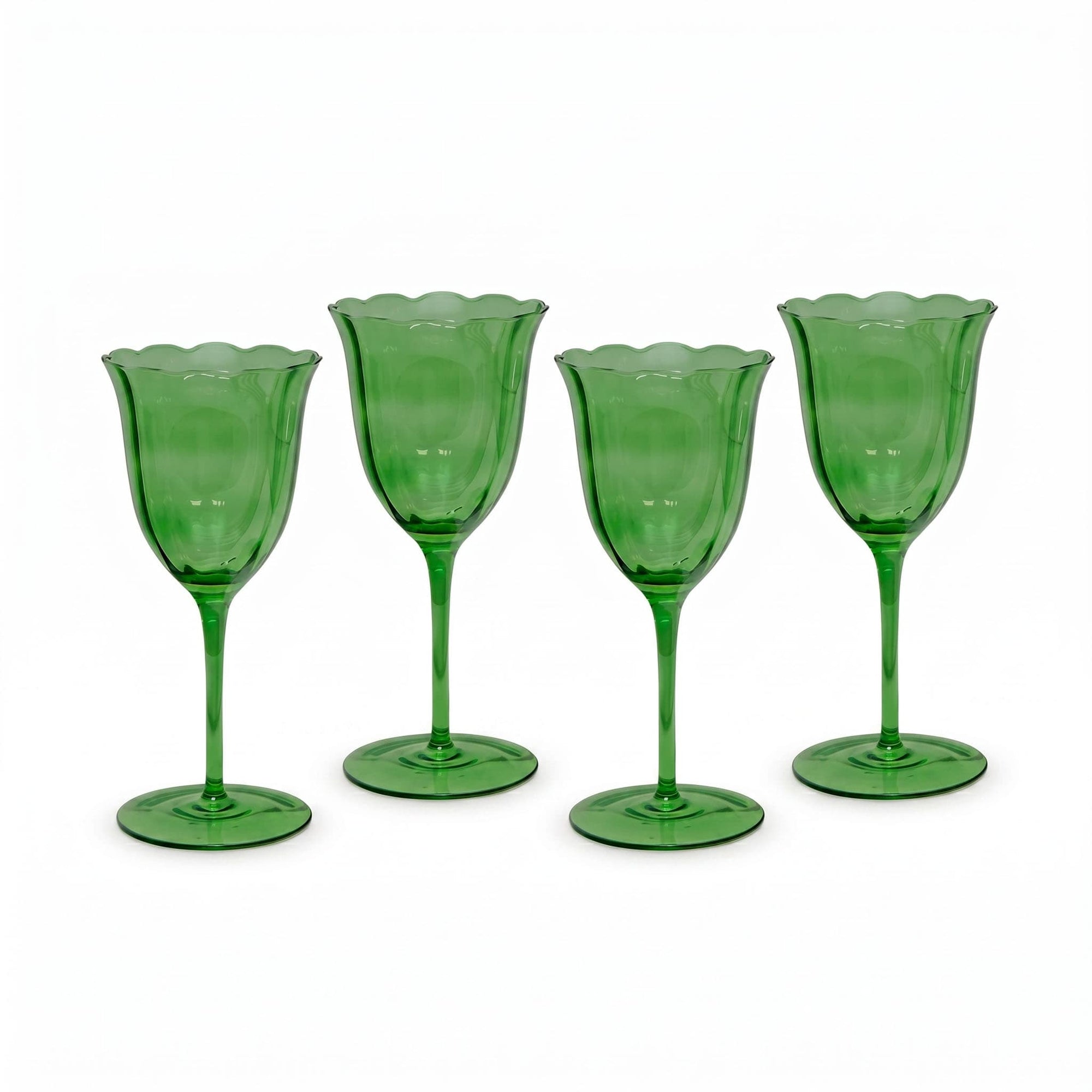 Four green glass goblets on a white background
