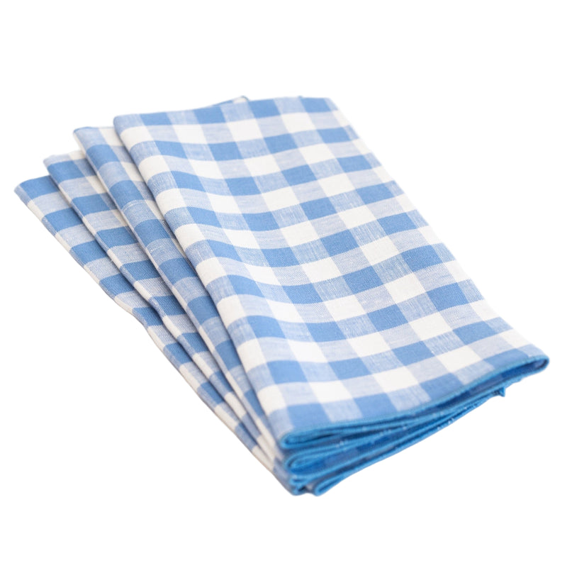 Set of three blue and white checkered napkins on a white background