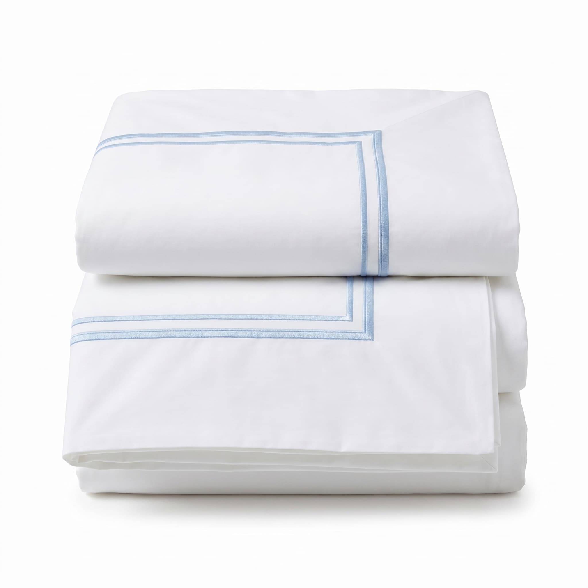Folded white comforter with blue stitching on a light gray background