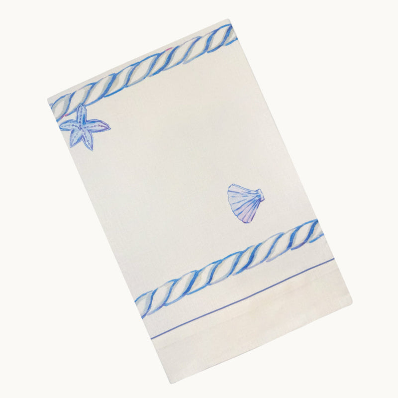 White towel with blue shell and rope design on a white background
