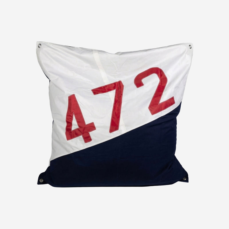 Decorative pillow with red numbers 472 on a white and navy background