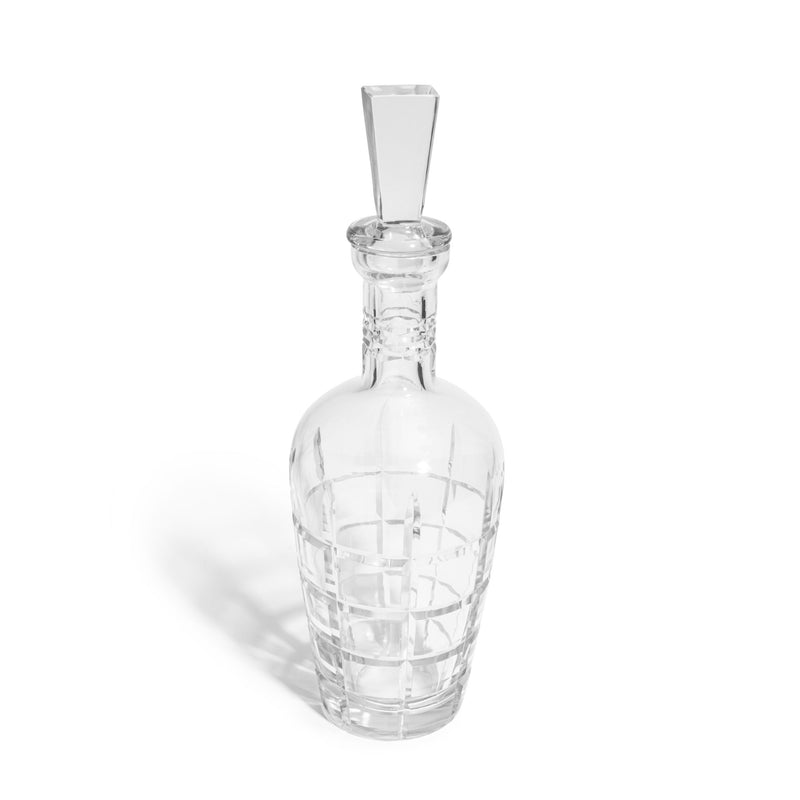 Clear glass decanter with geometric pattern on a white background