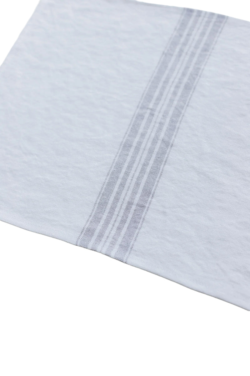 Close-up of a light blue fabric with a subtle pattern on a white background