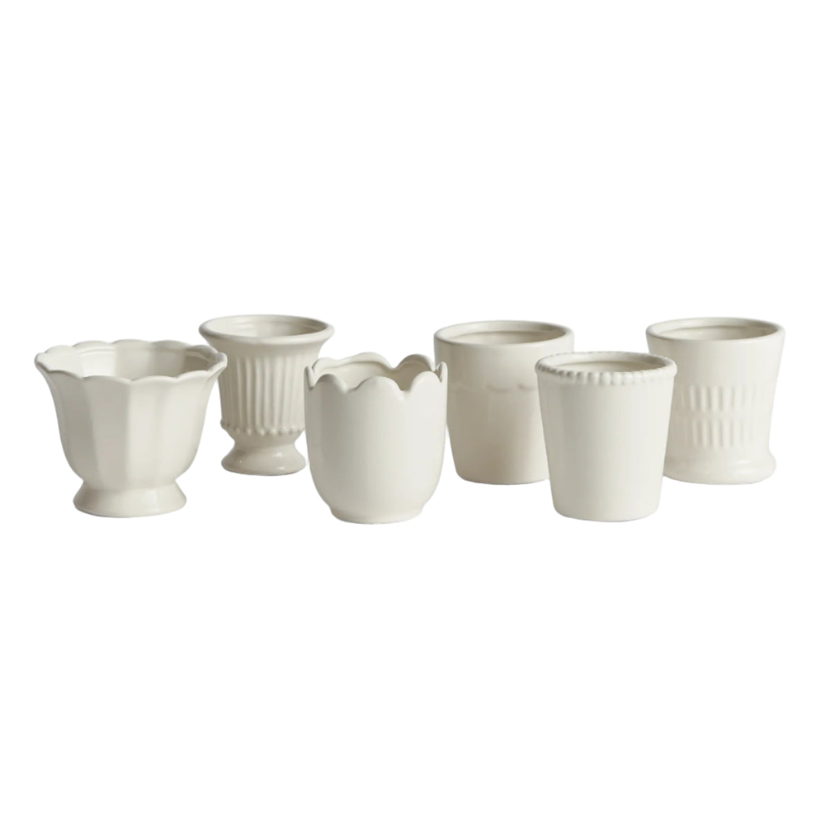 Set of white ceramic cups on a white background
