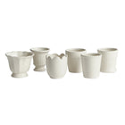 Set of white ceramic cups on a white background