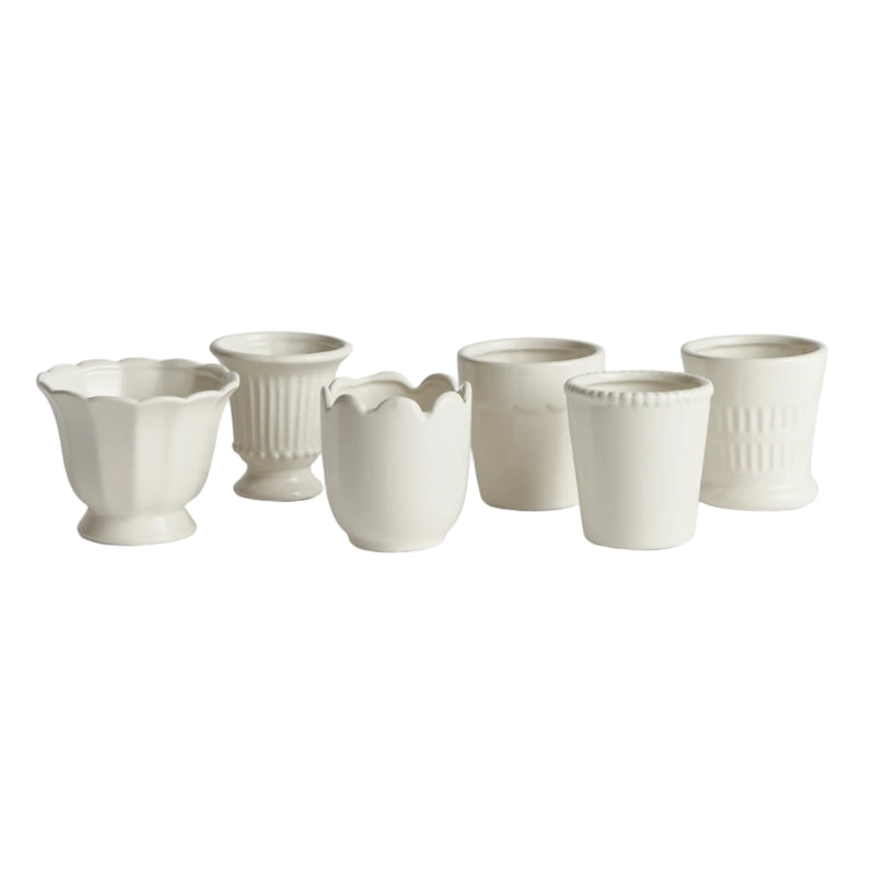 Set of white ceramic cups on a white background
