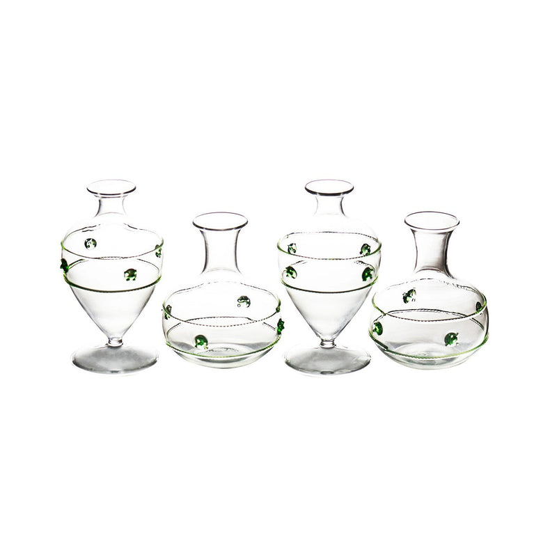 Set of glass decanters and bowls with green accents on a white background