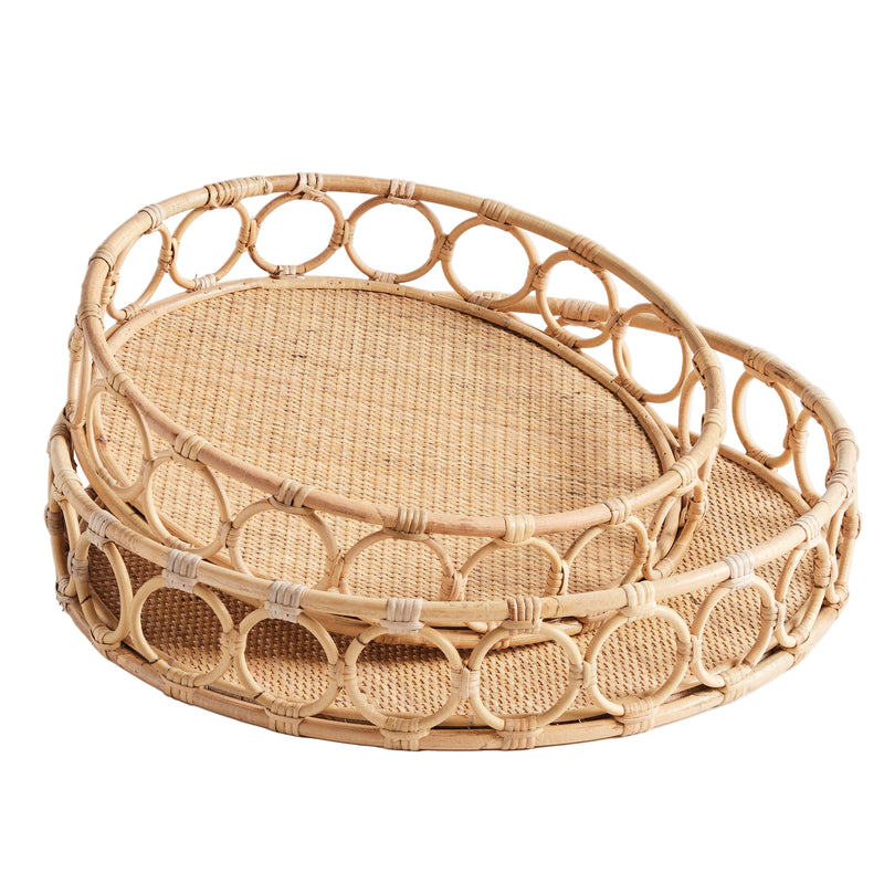 Two circular woven trays with circles around edge on white background