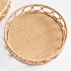 Top view of circular woven tray with circles around edge on white background