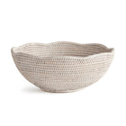 Woven off-white bowl with scalloped edge on white background