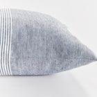Close up of square pinstripe pillow in blue and white on a white background