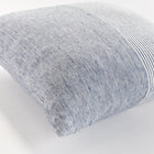 Close up of square pinstripe pillow in blue and white on a white background