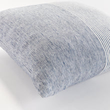 Close up of square pinstripe pillow in blue and white on a white background