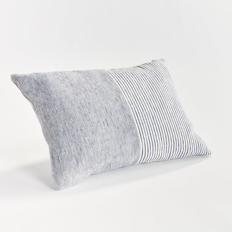 Rectangular pillow with thin blue stripes on white background