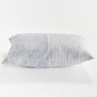 Rectangular pillow with thin blue stripes on white background