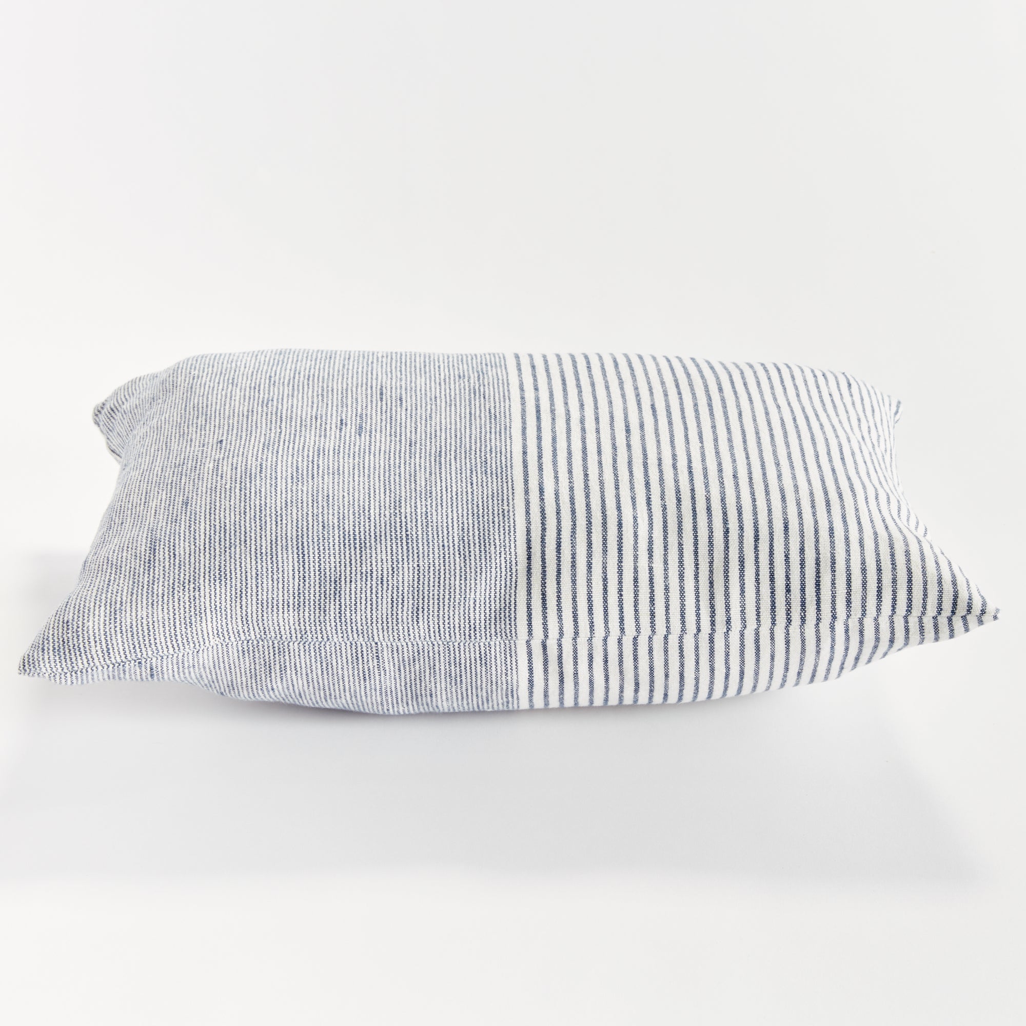 Rectangular pillow with thin blue stripes on white background