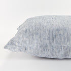 Close up of rectangular pillow with thin blue stripes on white background