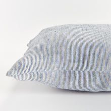Close up of rectangular pillow with thin blue stripes on white background