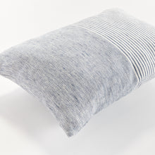Close up of rectangular pillow with thin blue stripes on white background