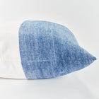Half blue and half white square pillow on white background