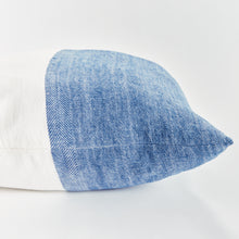 Half blue and half white square pillow on white background