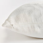 Close up of white square pillow zipper on white background