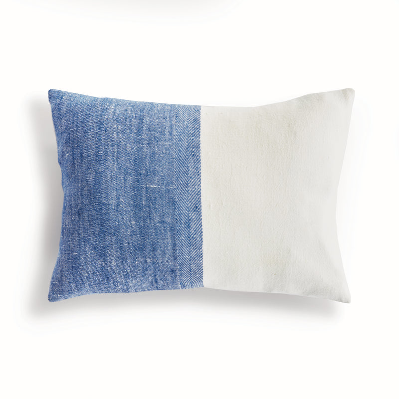 Half blue and half white rectangular pillow on white background