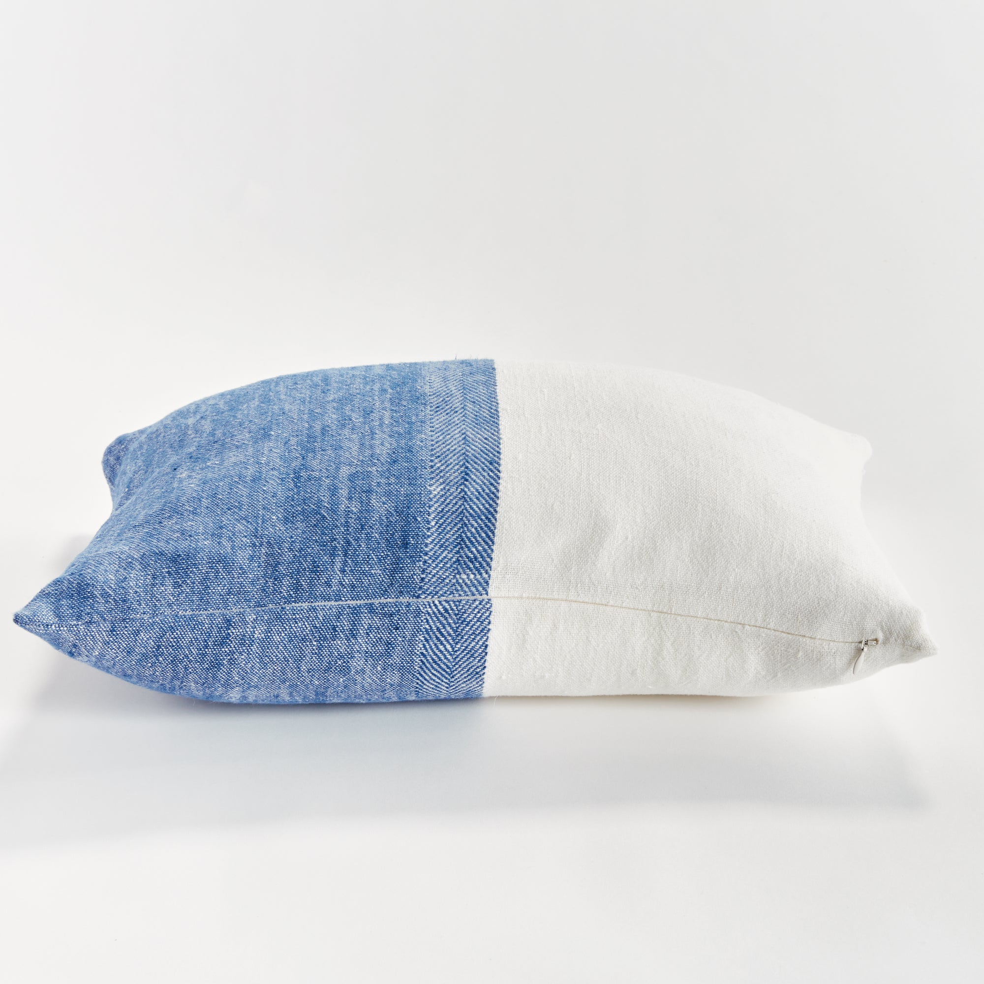 Half blue and half white rectangular pillow on white background