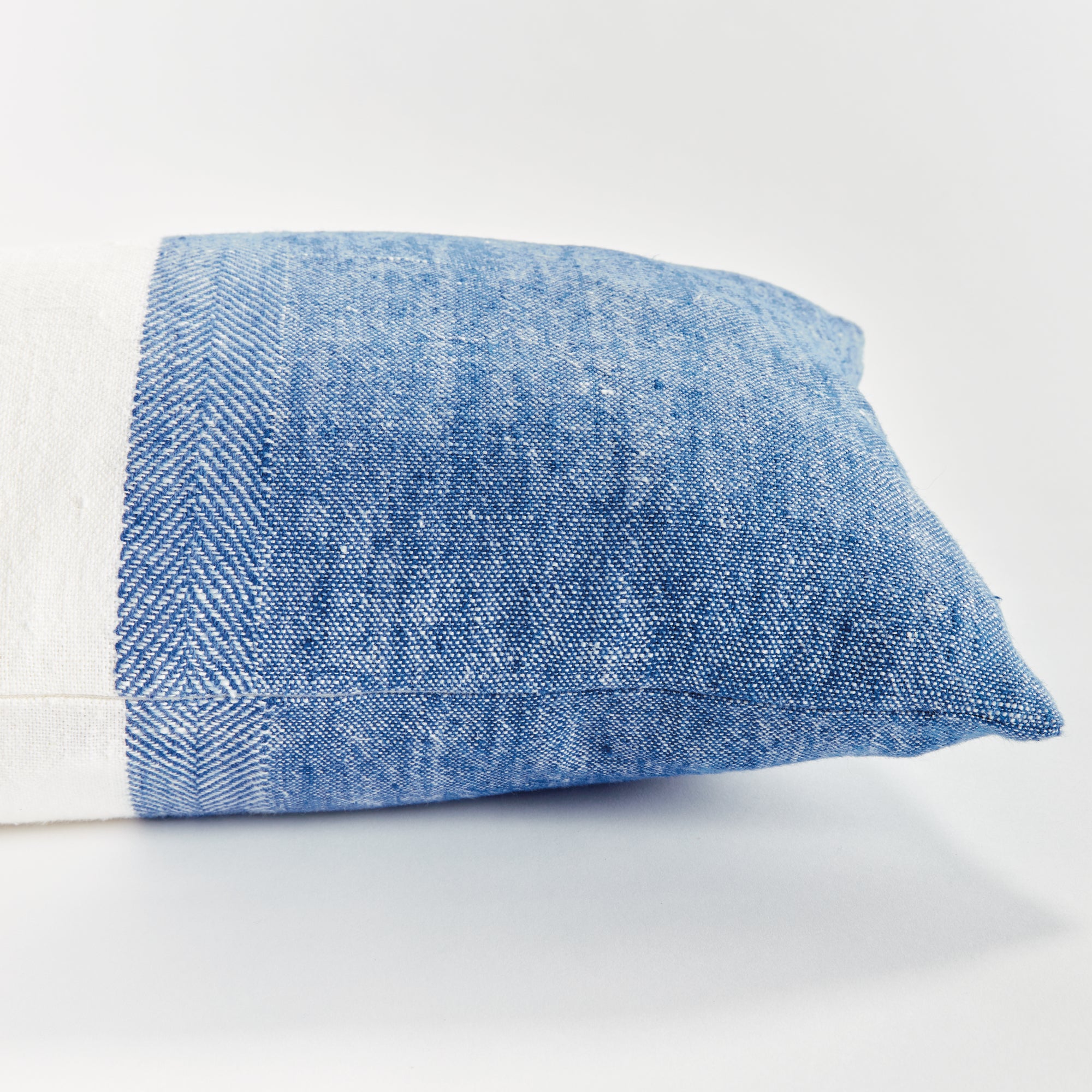 Half blue and half white rectangular pillow on white background