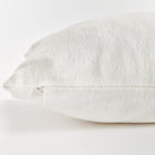 Close up of white rectangular pillow zipper on white background